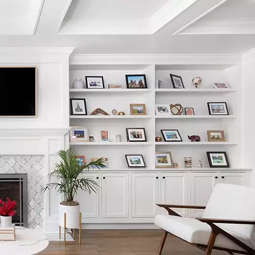 Bright Living Room featuring Built-In Shelving and Cabinets