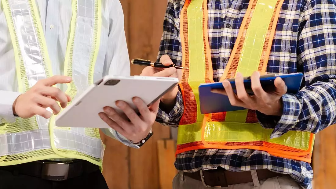 Builders Looking at Tablets